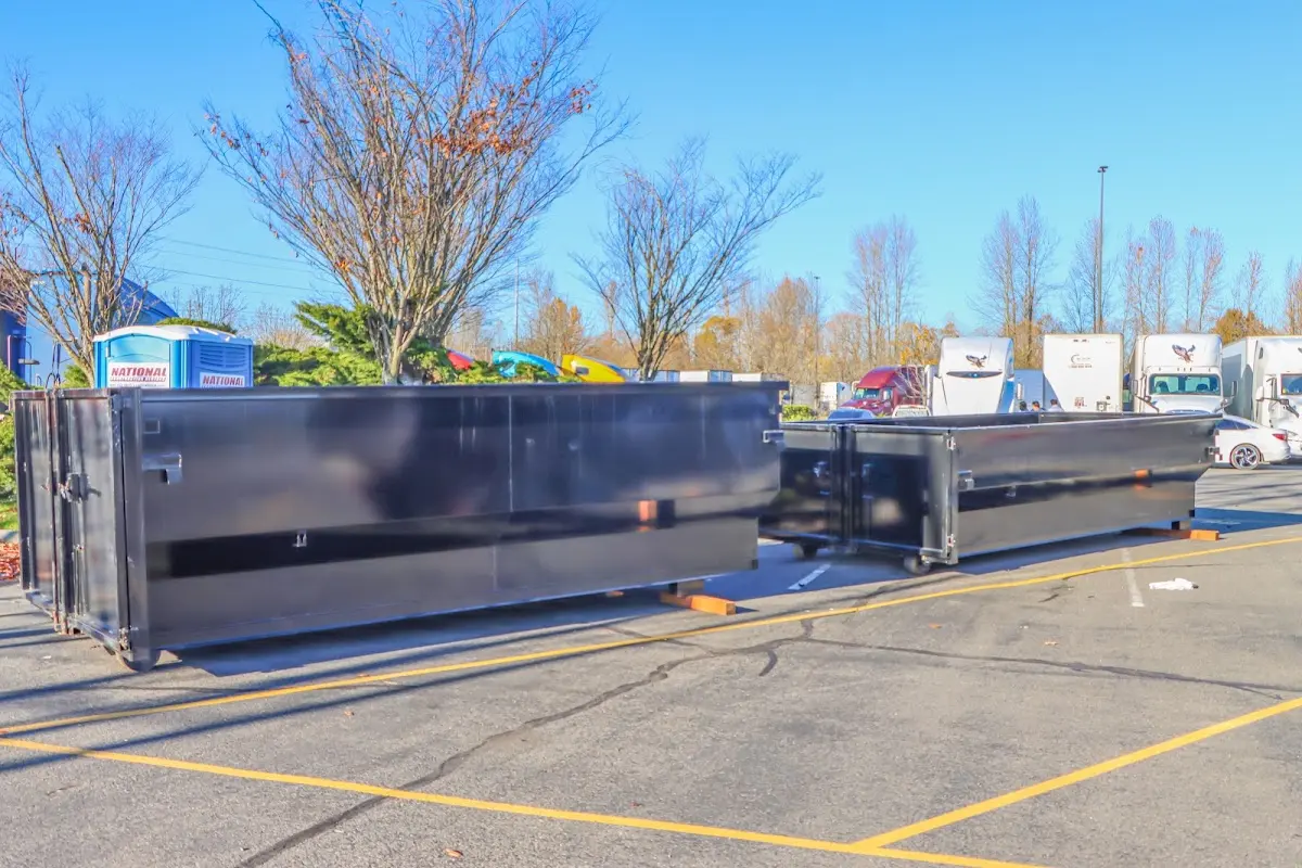 Professional dumpster rental service with roll-off container on residential driveway in Sea Cliff